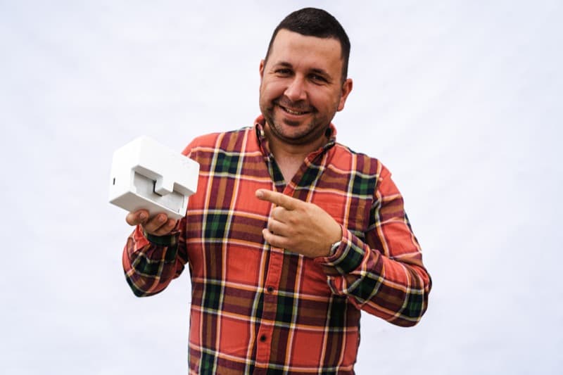 Livestock breeder holding Ongo Vision device in the field